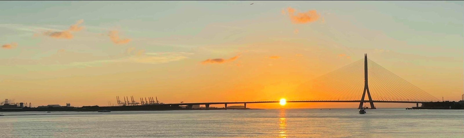 Danjiang Bridge and sunset over the Tamsui River